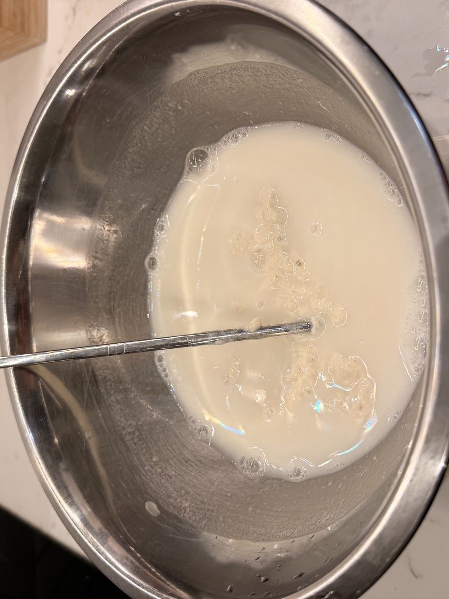 Active sourdough starter mixed with water showing milky, cloudy consistency